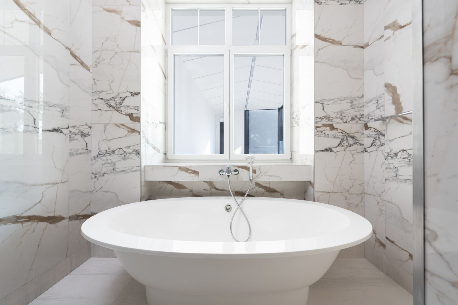 Marble bathroom with freestanding tub in a luxury custom home