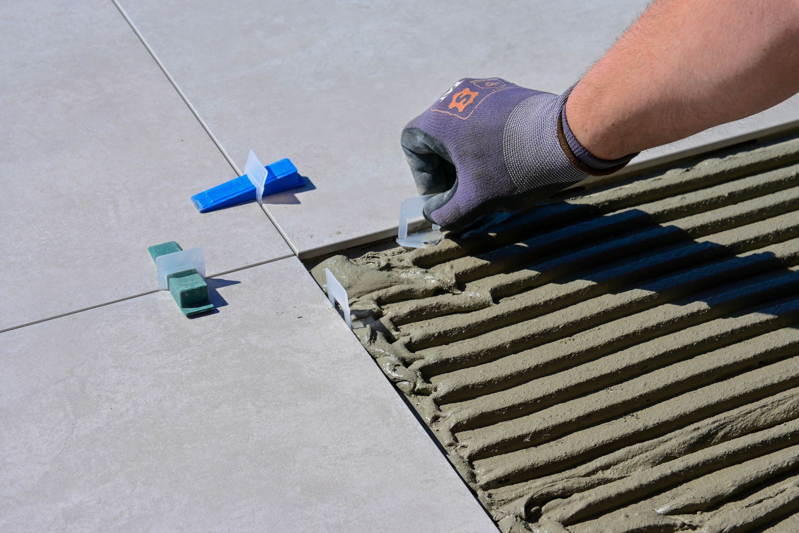 Craftsman installing tile in a design-build custom home